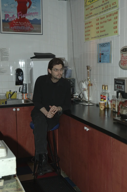 a man sitting at the bar of a diner