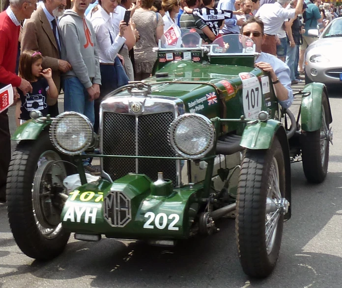 a green race car with numbers that read 1204 ah on the side