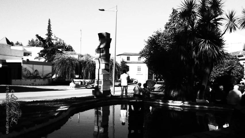 people are gathered outside in front of a pool