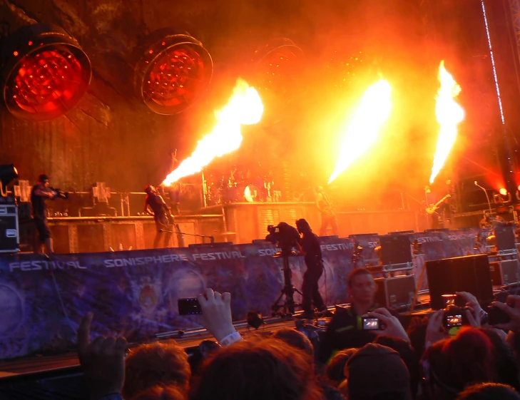 the stage is lit up with bright red and yellow light