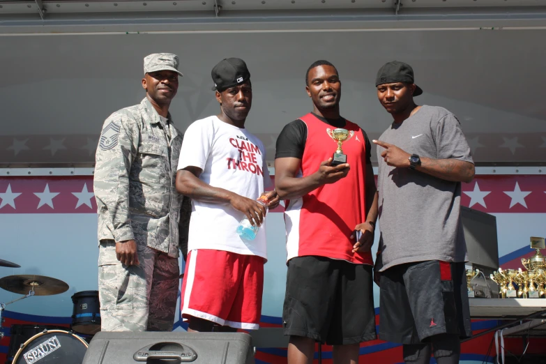 four young men are standing near each other