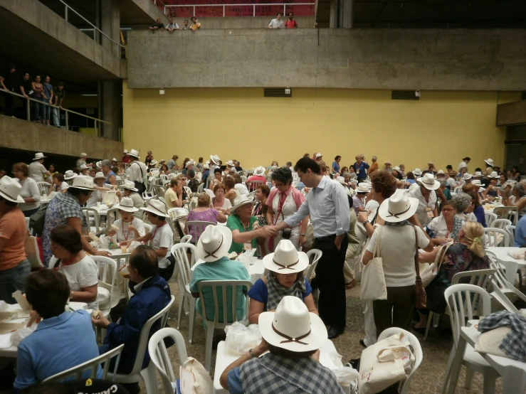 a large crowd of people seated at tables
