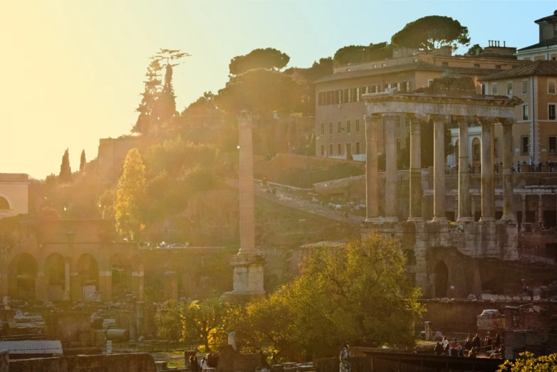 the sun is shining down on the ancient ruins and trees