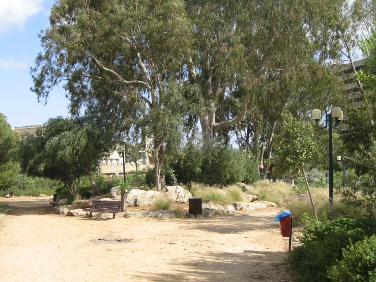 a couple of benches sitting on top of a dirt ground