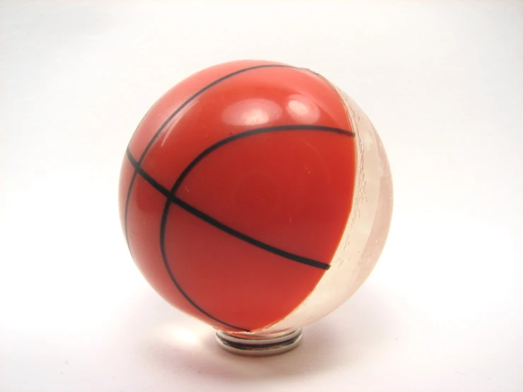 a red and white ball and a metal stand