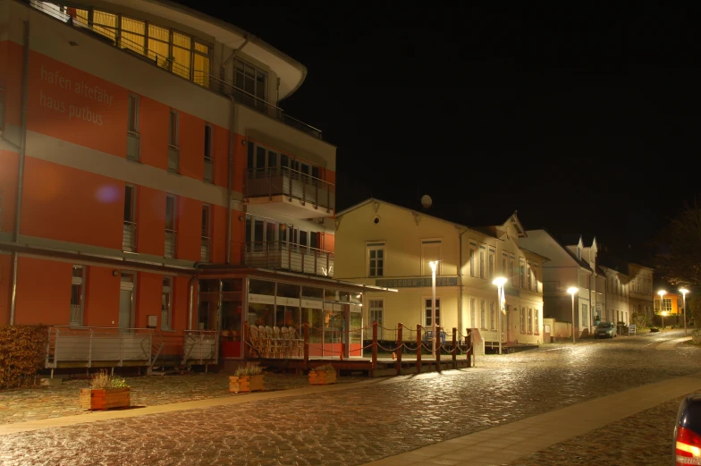 a couple of buildings sit in the middle of a small road