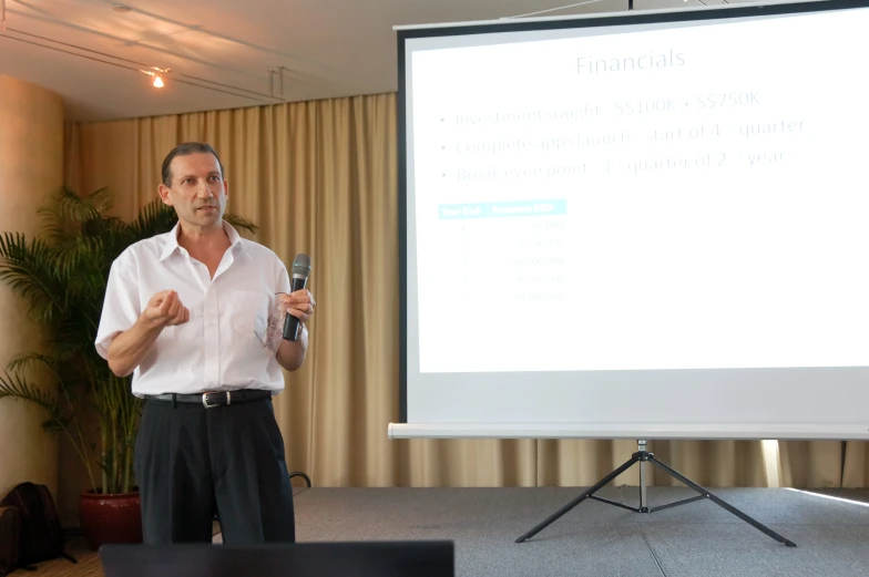 a man giving a presentation on what he is writing