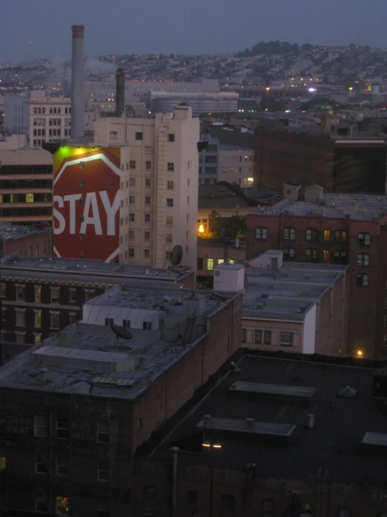 the city is lit up for twilight with neon signs on the buildings