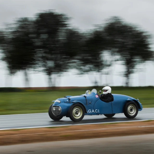 a classic race car with a blue finish line