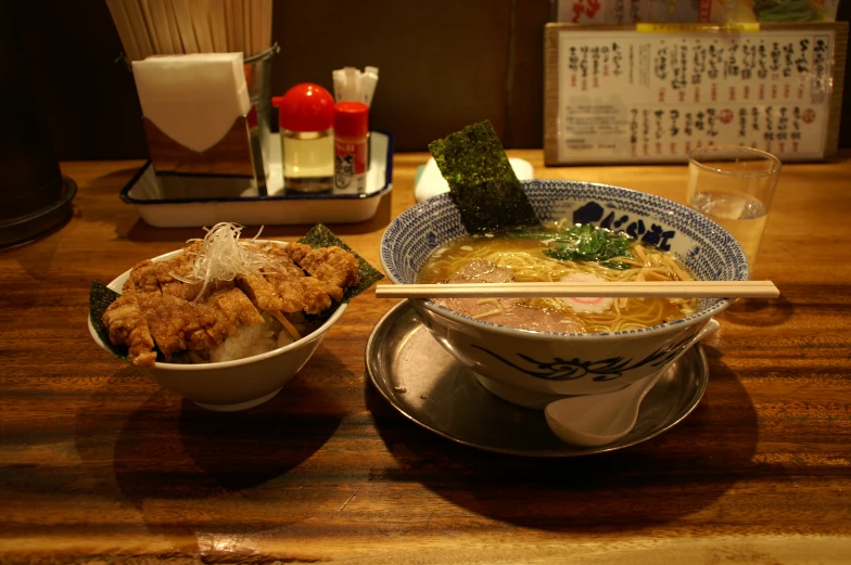 a bowl of ramen and chopsticks is shown on the table
