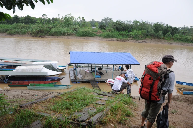 several people are at the docks in a lake