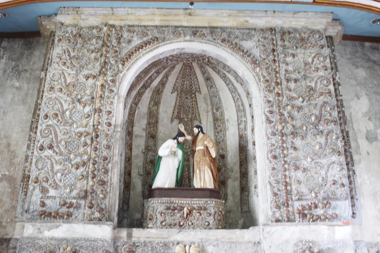 two people with robes standing in the corner of a building