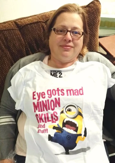 a lady wearing a white shirt with a yellow minion on it