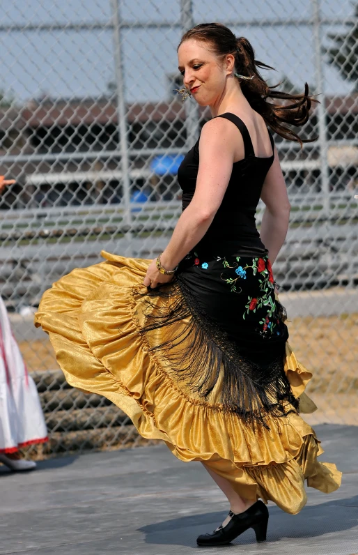 a woman wearing a yellow dress and black high heels