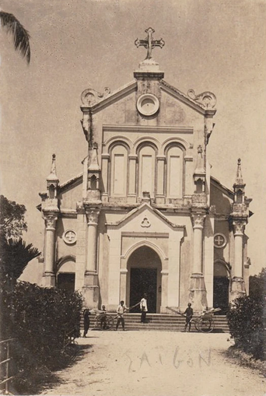 an old po shows people in front of a large church