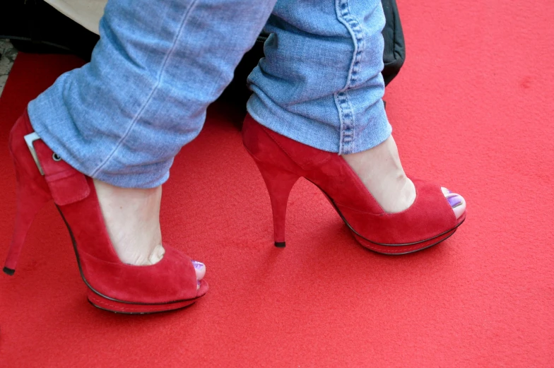 a pair of feet wearing red  sandals