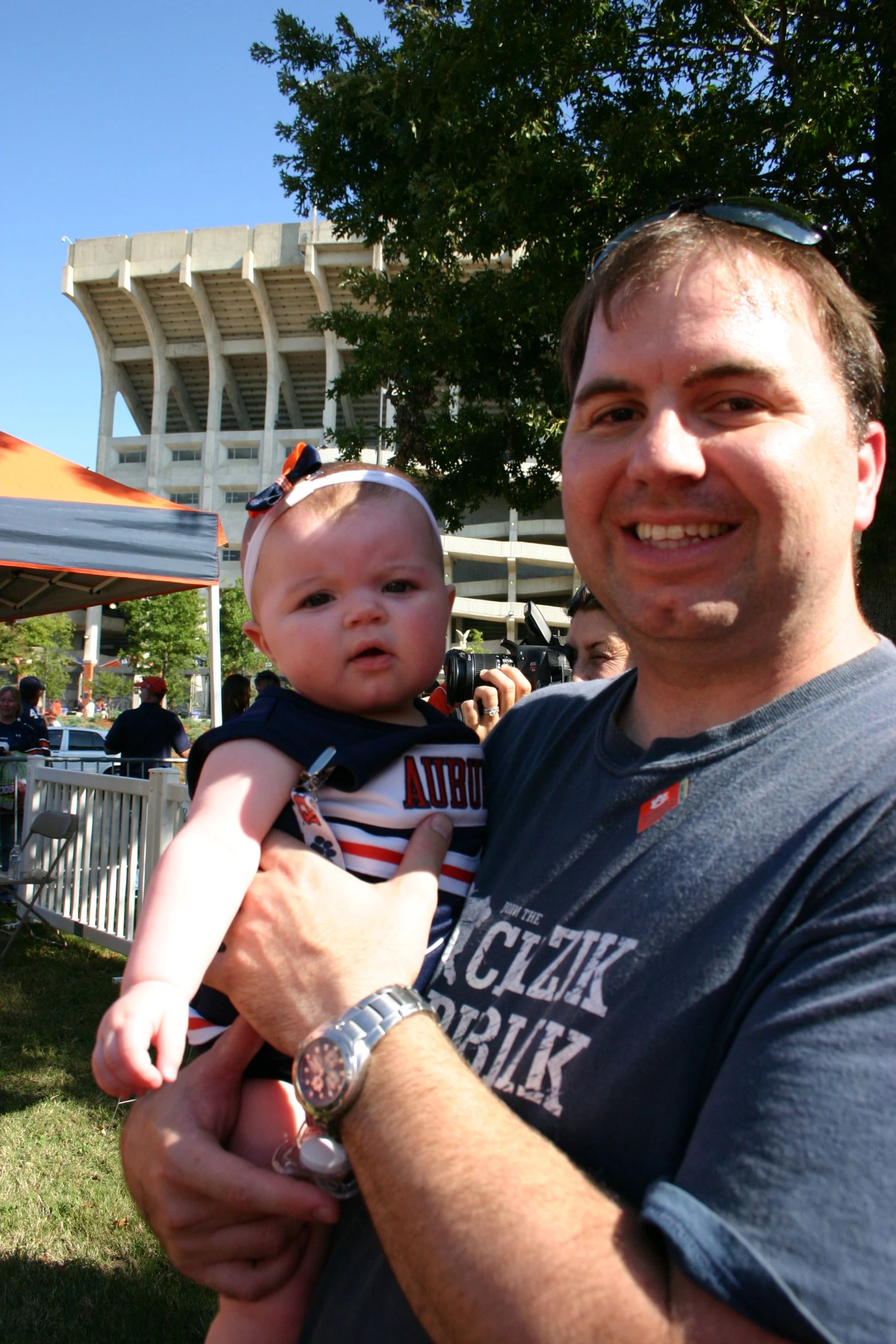 a man holds up a baby in his arms