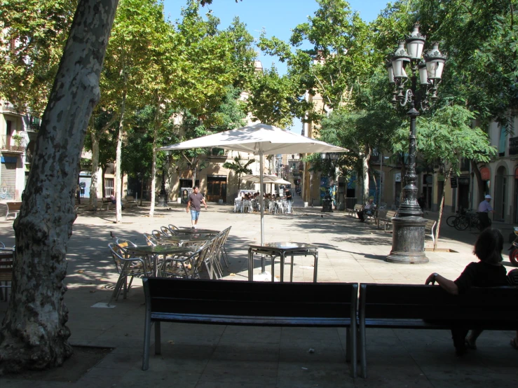 a park with many benches and tables in the middle