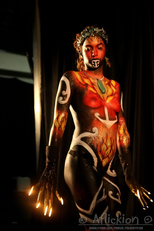 an artistic body - art woman in gold and black poses