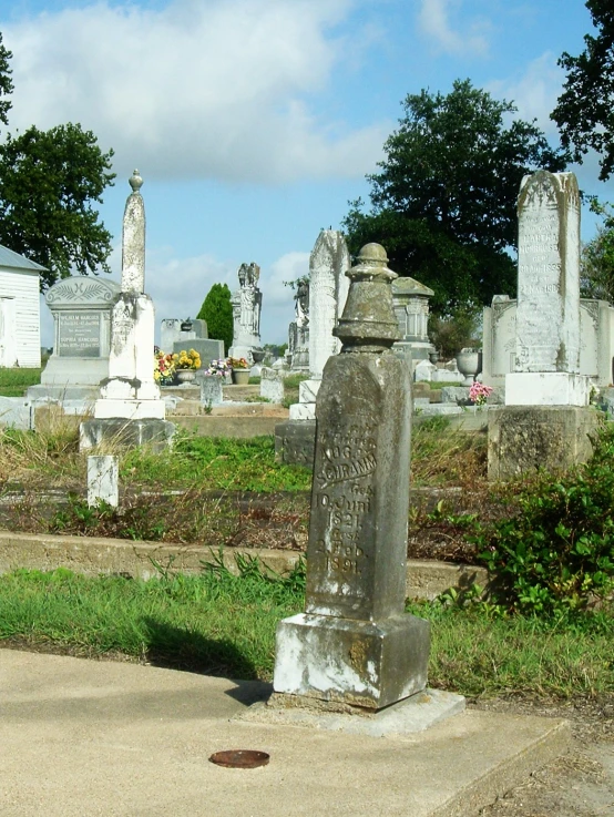 there is a old grave at the corner of a cemetery