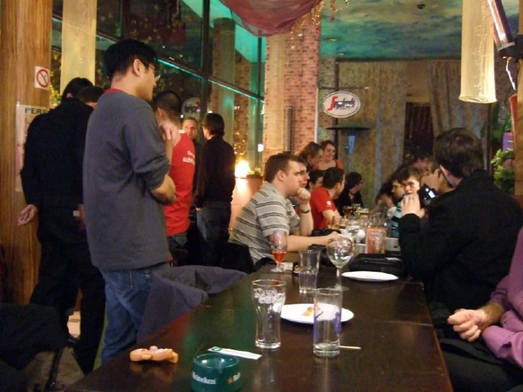 a number of people sitting at a table with some glasses