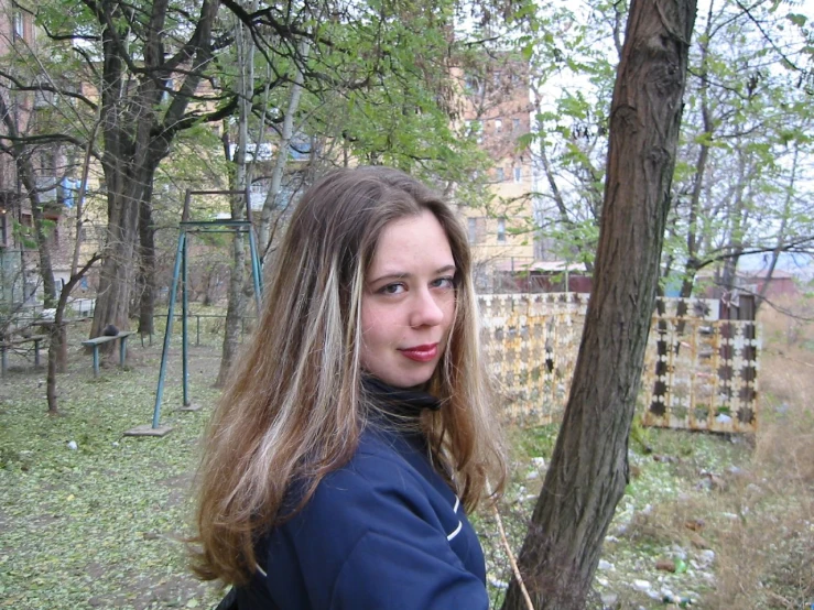 a girl with long hair in a park