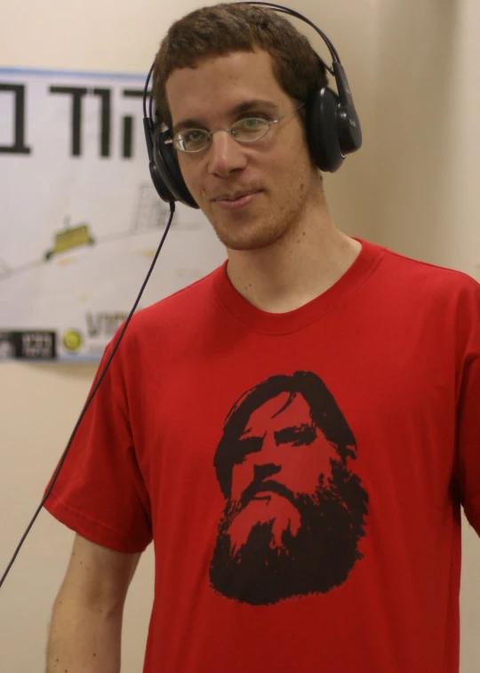 young man with glasses and headphones making silly face