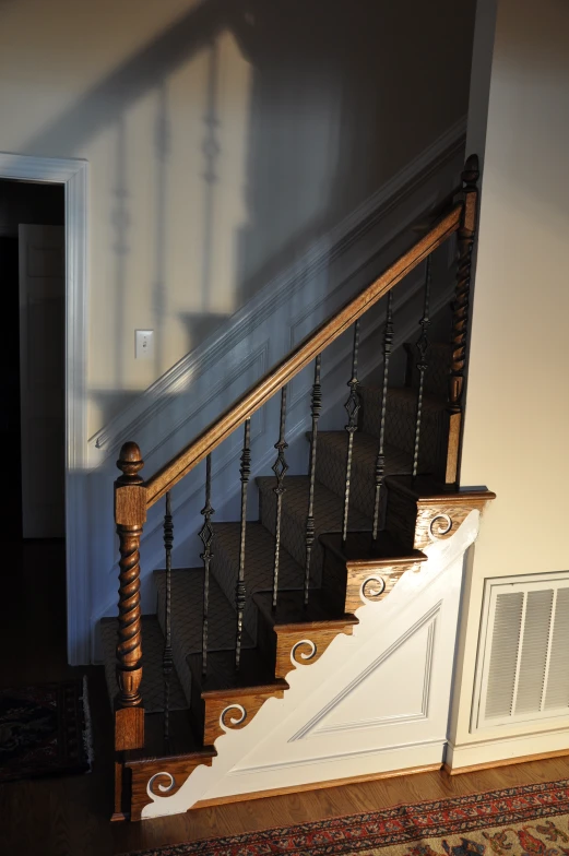 staircase in home with wooden hand rail and stair railing