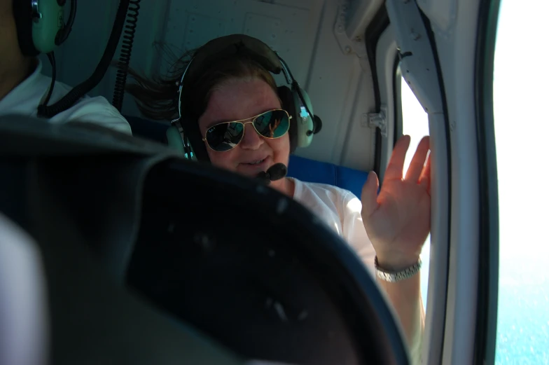 woman with headphones in the air and talking on her cell phone