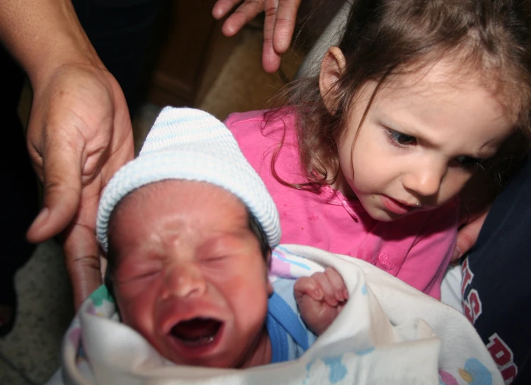 the baby is crying in his crib, while parents hands him