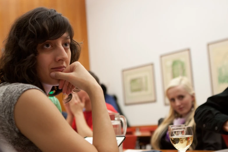 several women sitting at a table and talking