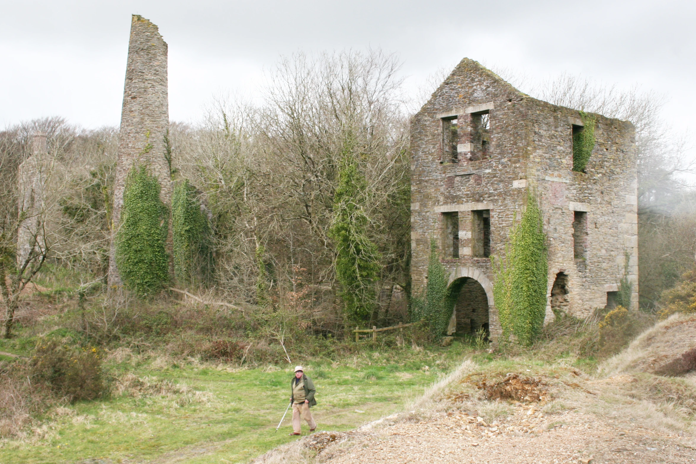 a brick building with trees and a person in front of it