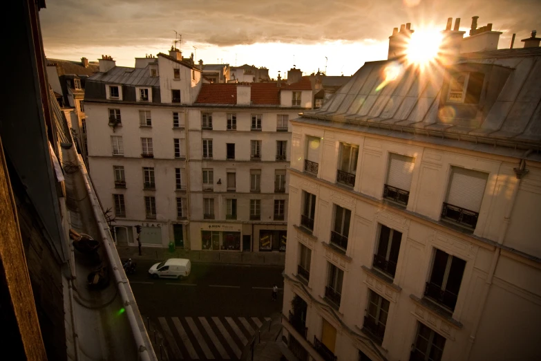 an aerial view of a street and buildings near sunset