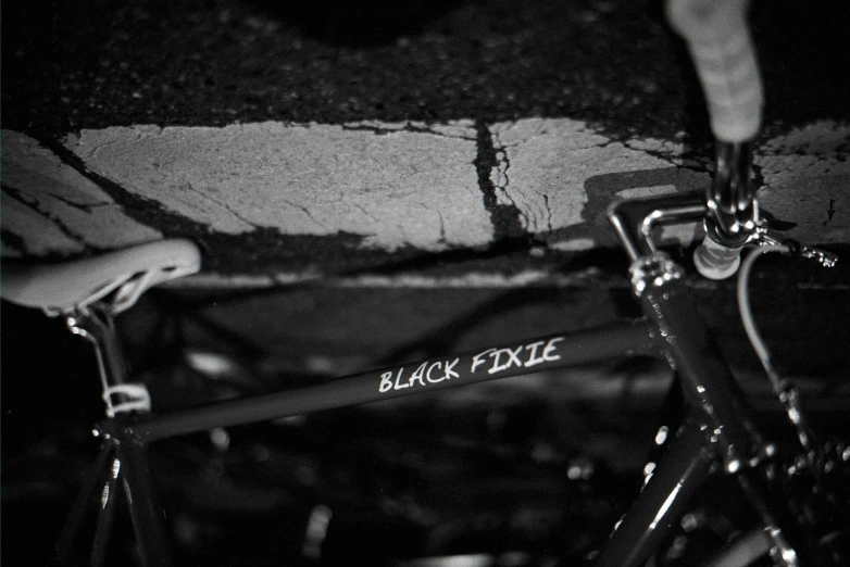 black fixie logo on the handle bars of a bicycle