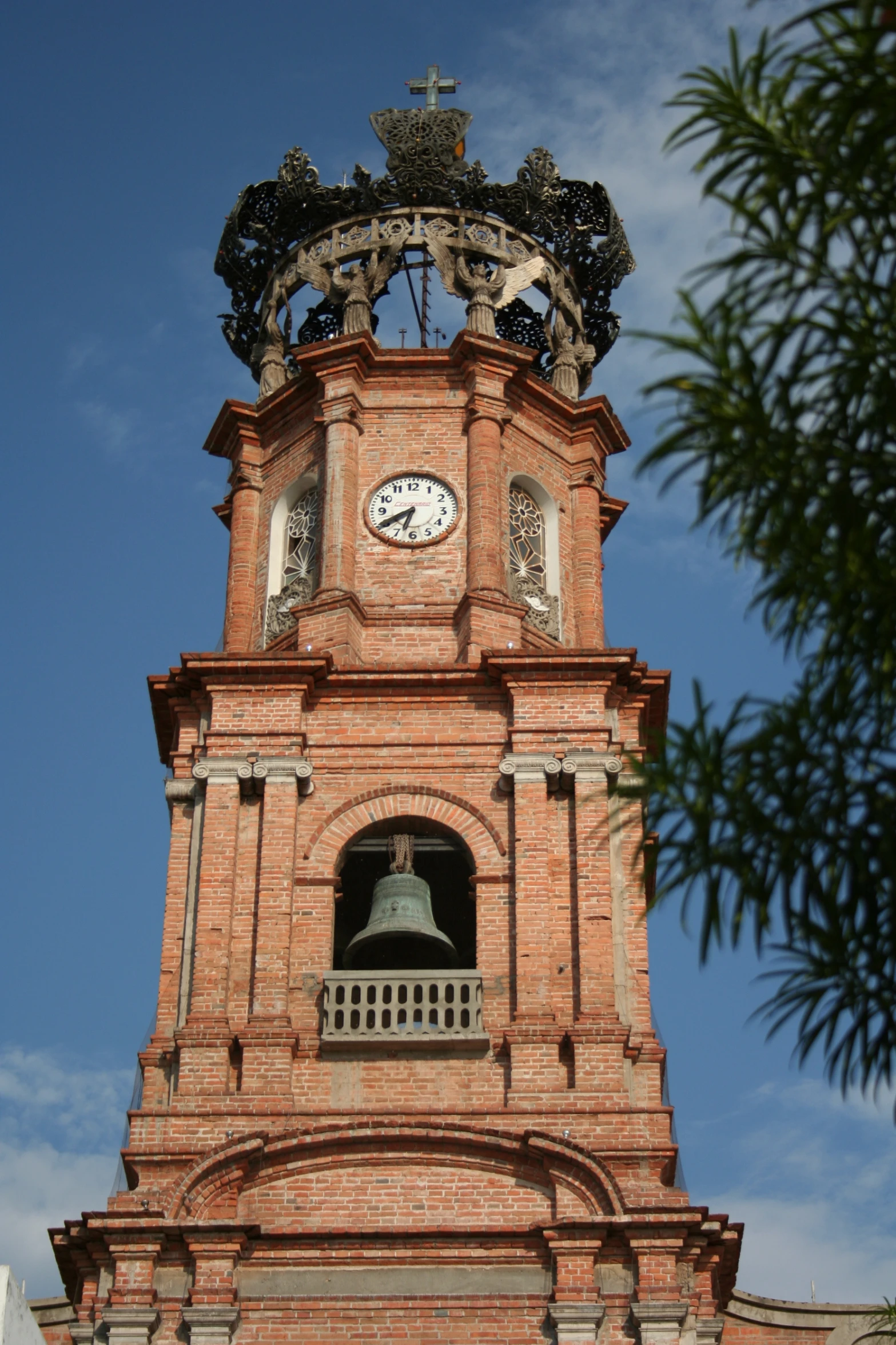 a large clock tower with ornate bells and a bell