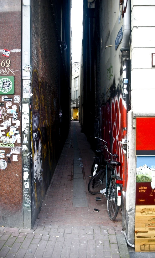 two bikes are parked up against a wall