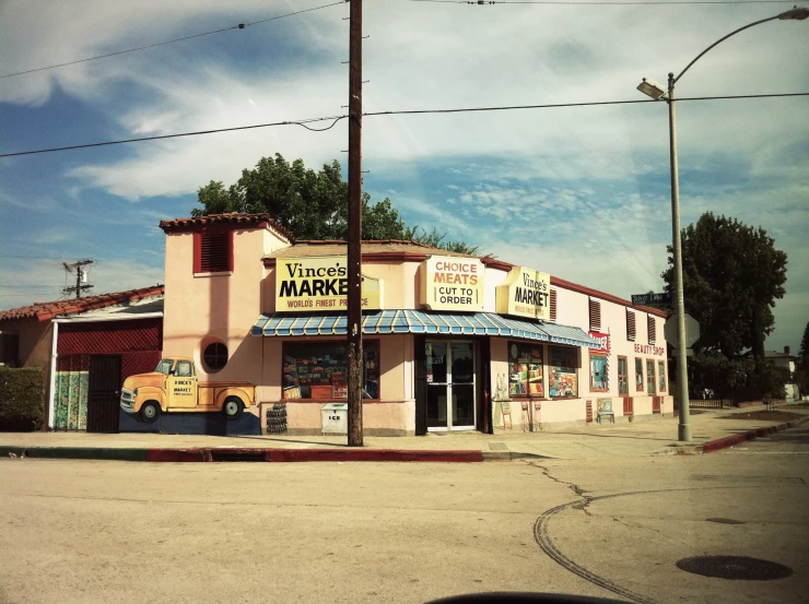 an old western town with signs for storefronts