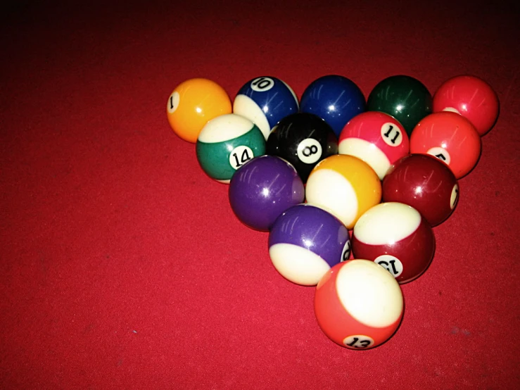 several pool balls scattered on a red floor