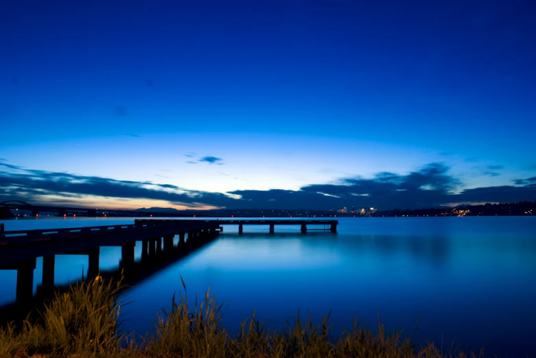 the water has a large long wooden bridge