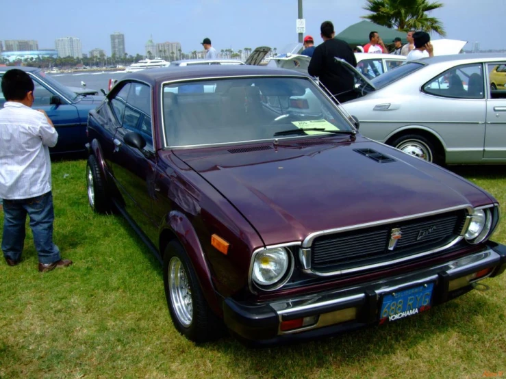 a classic car that is being parked on grass