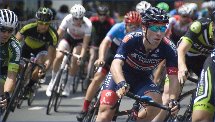 a bunch of men riding bikes in a bike race