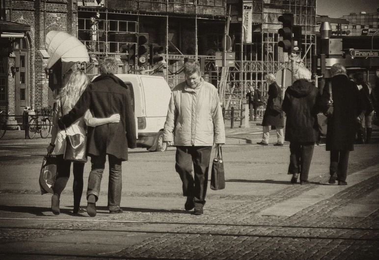 a man walking down the street past a large group of men