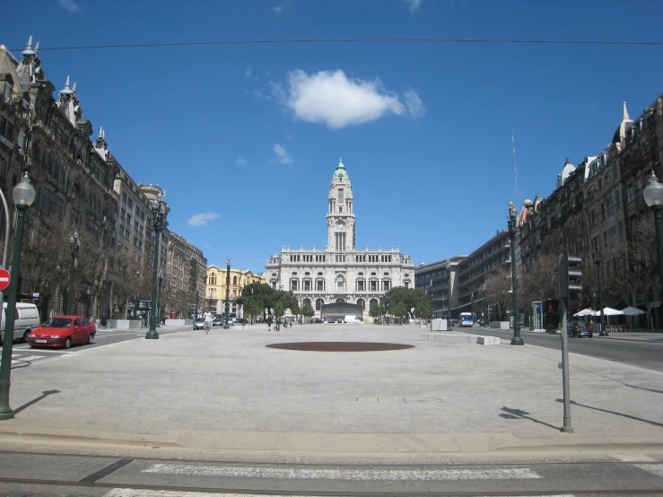 the empty square has a tall white building with a clock tower on it