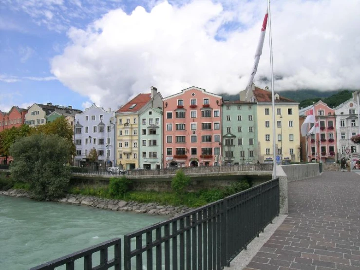 the buildings are along the bank of a river