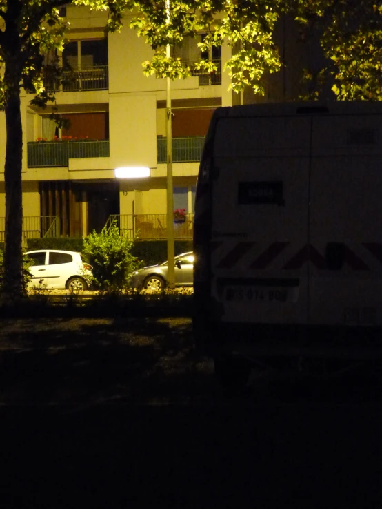 an suv is parked near a building at night