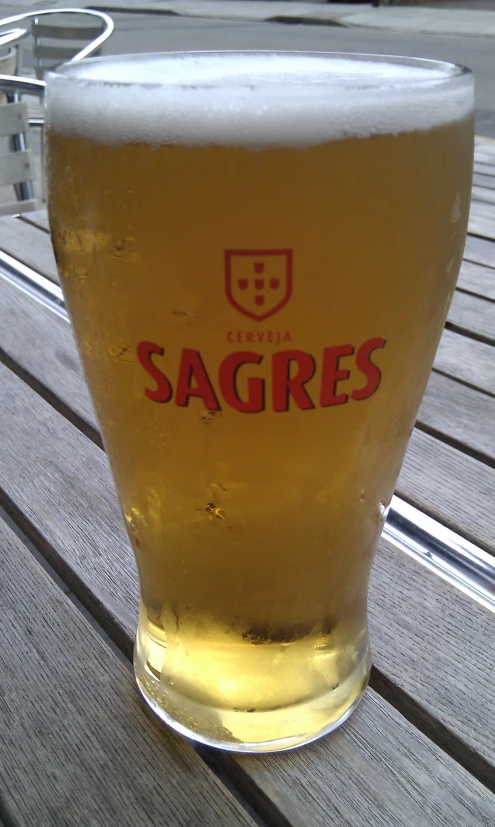 a glass of beer sits on a table