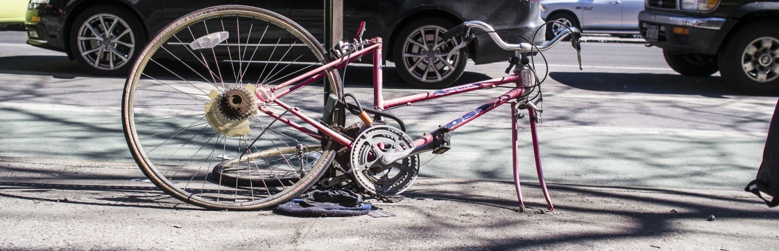 a red bicycle is sitting on the street