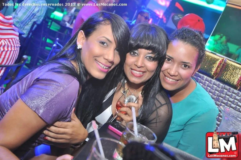 three young ladies are enjoying a good time in the night club