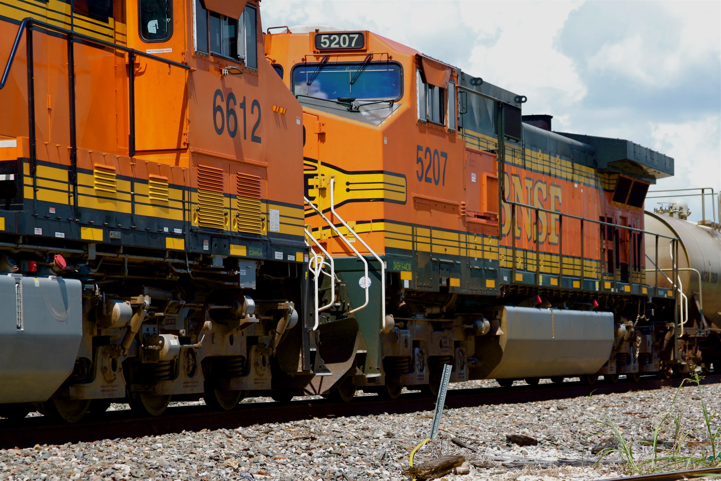 an orange and black train engine and tracks