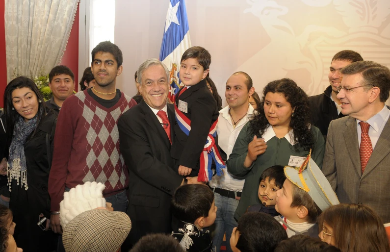 a group of people posing in front of two american and cuban flags